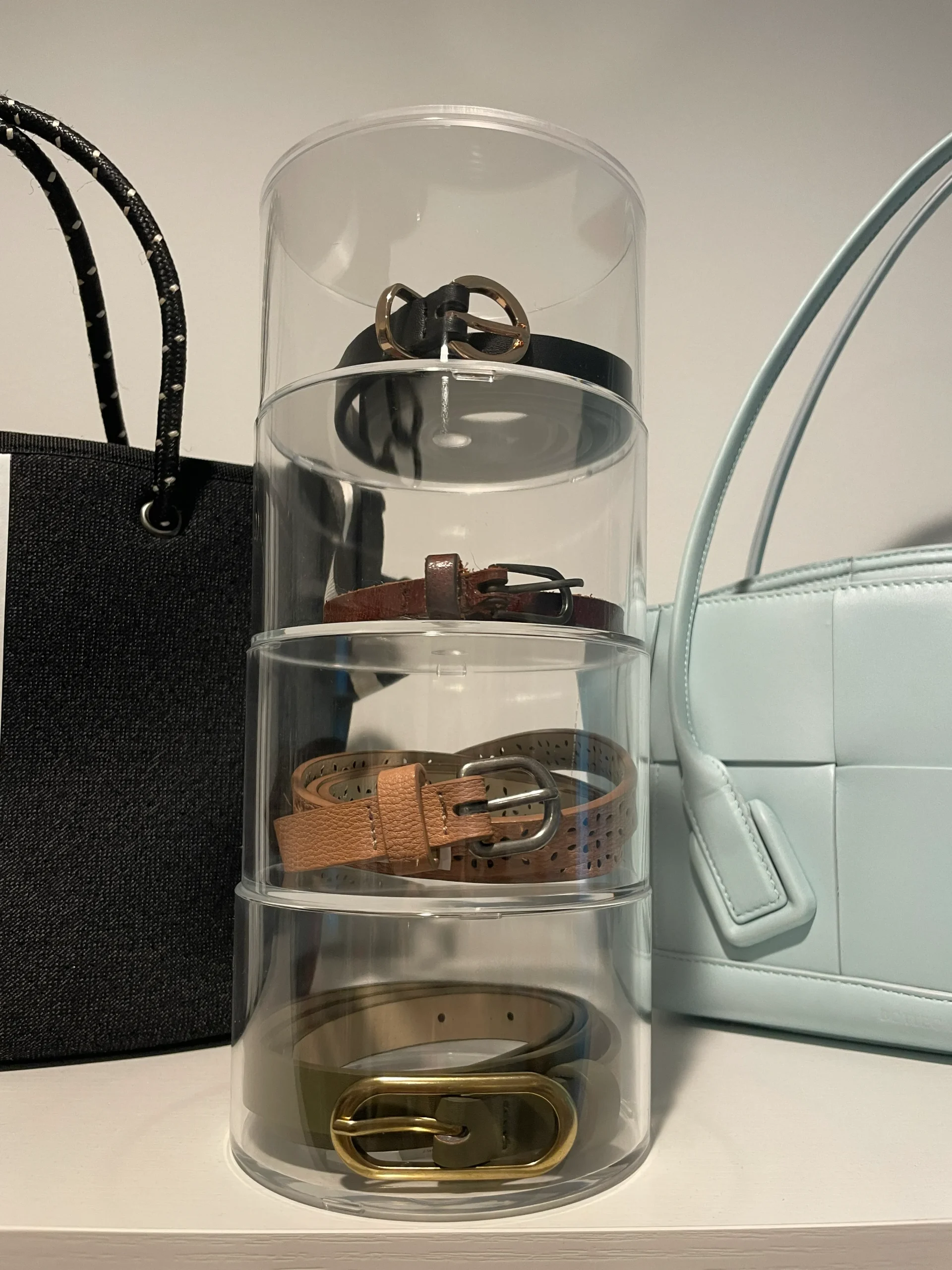 Clear acrylic belt organizer used for ADHD closet organization to maintain visibility and reduce clutter.